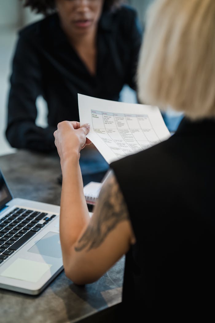Professionals discussing business documents in an office setting.