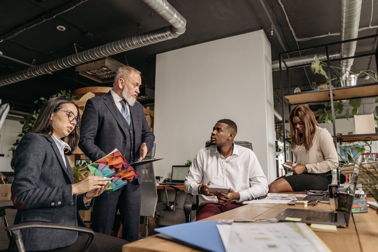 Diverse colleagues engaged in a business meeting in a contemporary office environment.